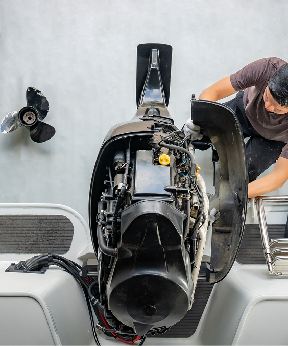 Technician servicing a wake boat at the Discovery Bay shop